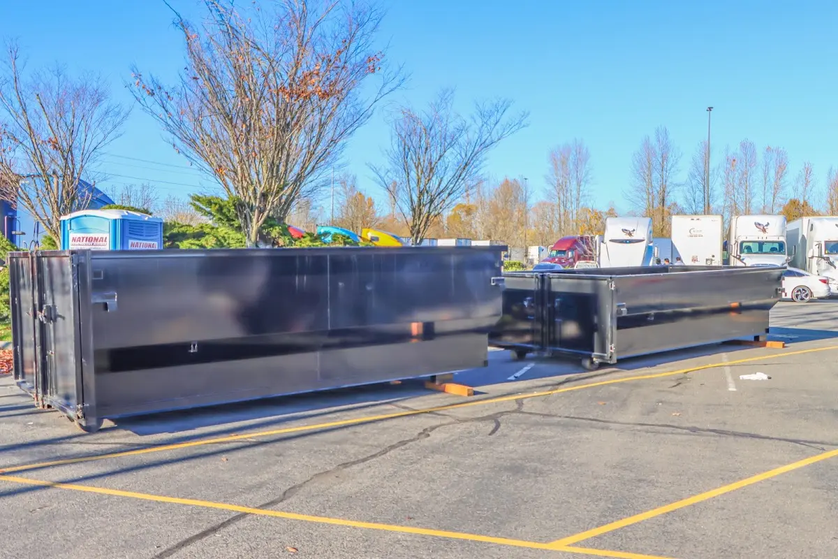 Professional dumpster rental service with roll-off container on residential driveway in Trenton